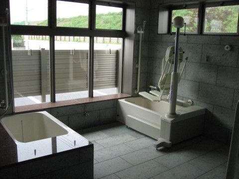 座ったまま入浴できるリフト付き介護浴槽と一般の浴槽がある。どちらも個浴で浴槽横の壁には縦に長い手すりが付いている。