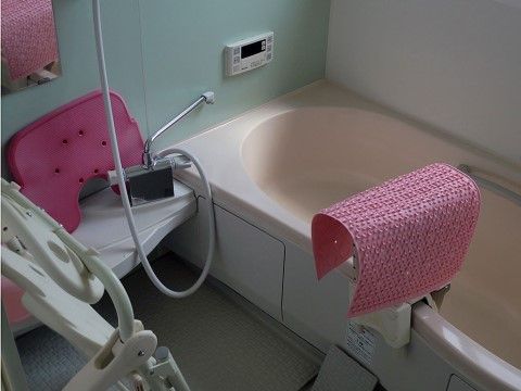 優しい色合いで落ち着く浴室はリラックスタイムを満喫できる。浴槽には滑り込み防止マットや、介護入浴機器も完備している。
