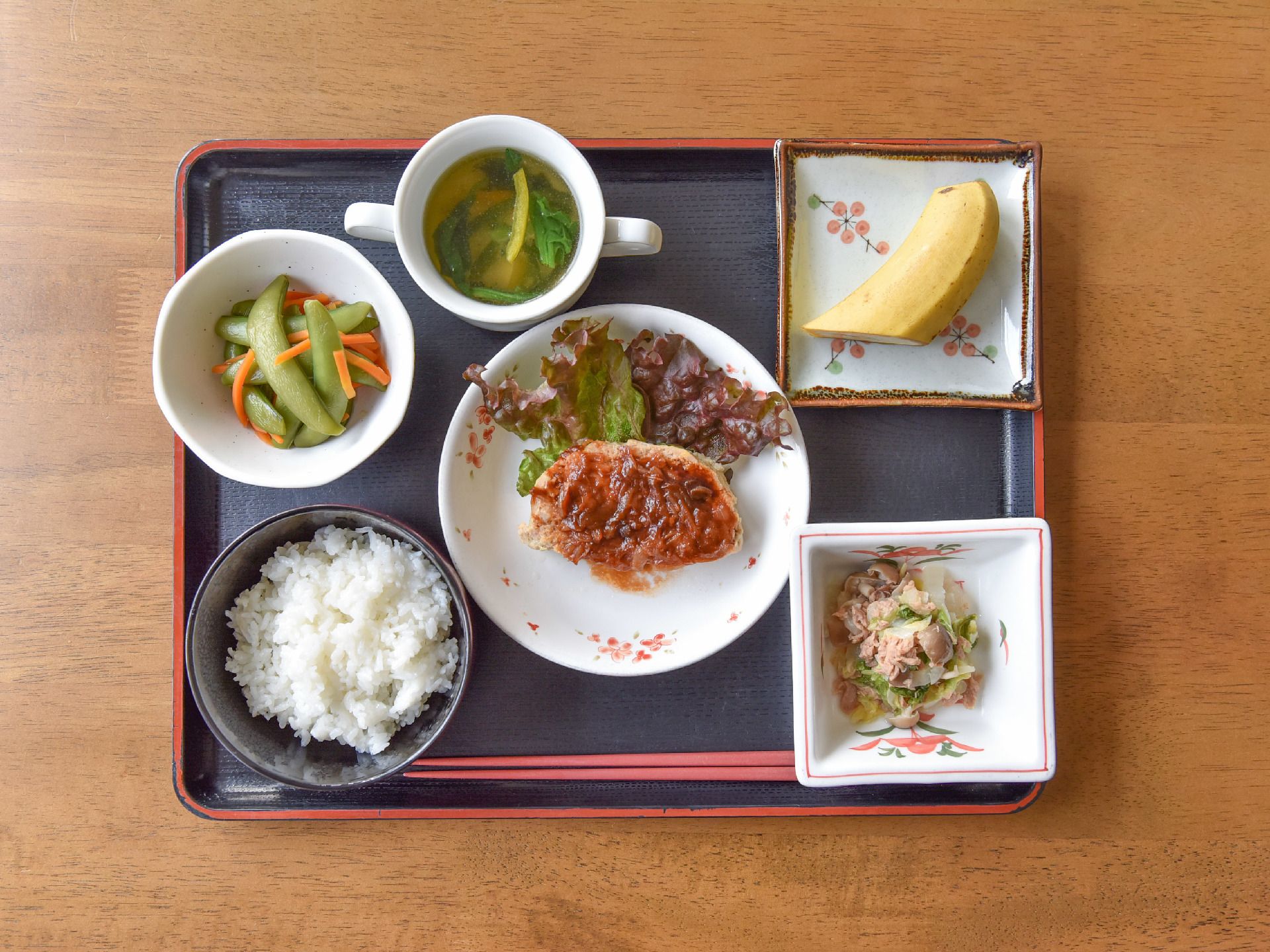 メニューの一例。主菜のハンバーグに、野菜を中心としたヘルシーな副菜が2種類、具が多い味噌汁、そしてバナナといったデザートも付いている。