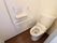 トイレは、白でまとめられたデザインである。隅々まで掃除が行き届いており清潔になっている。横の壁には、L字型の手すりがある。