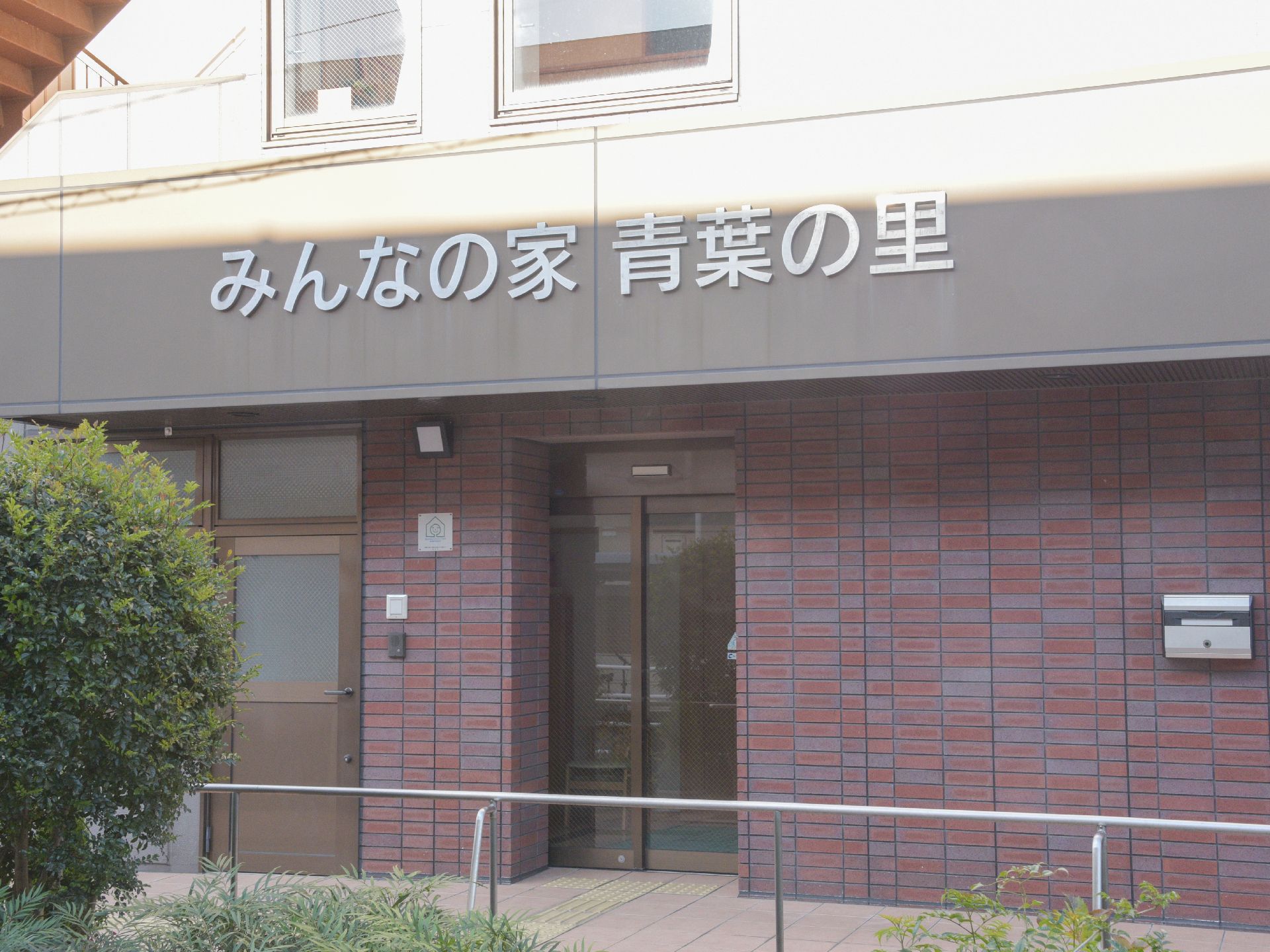 入り口には施設の名前が大きく表示されている。ドアは2種類用意されている。歩行スペースには手すりが設置してある。