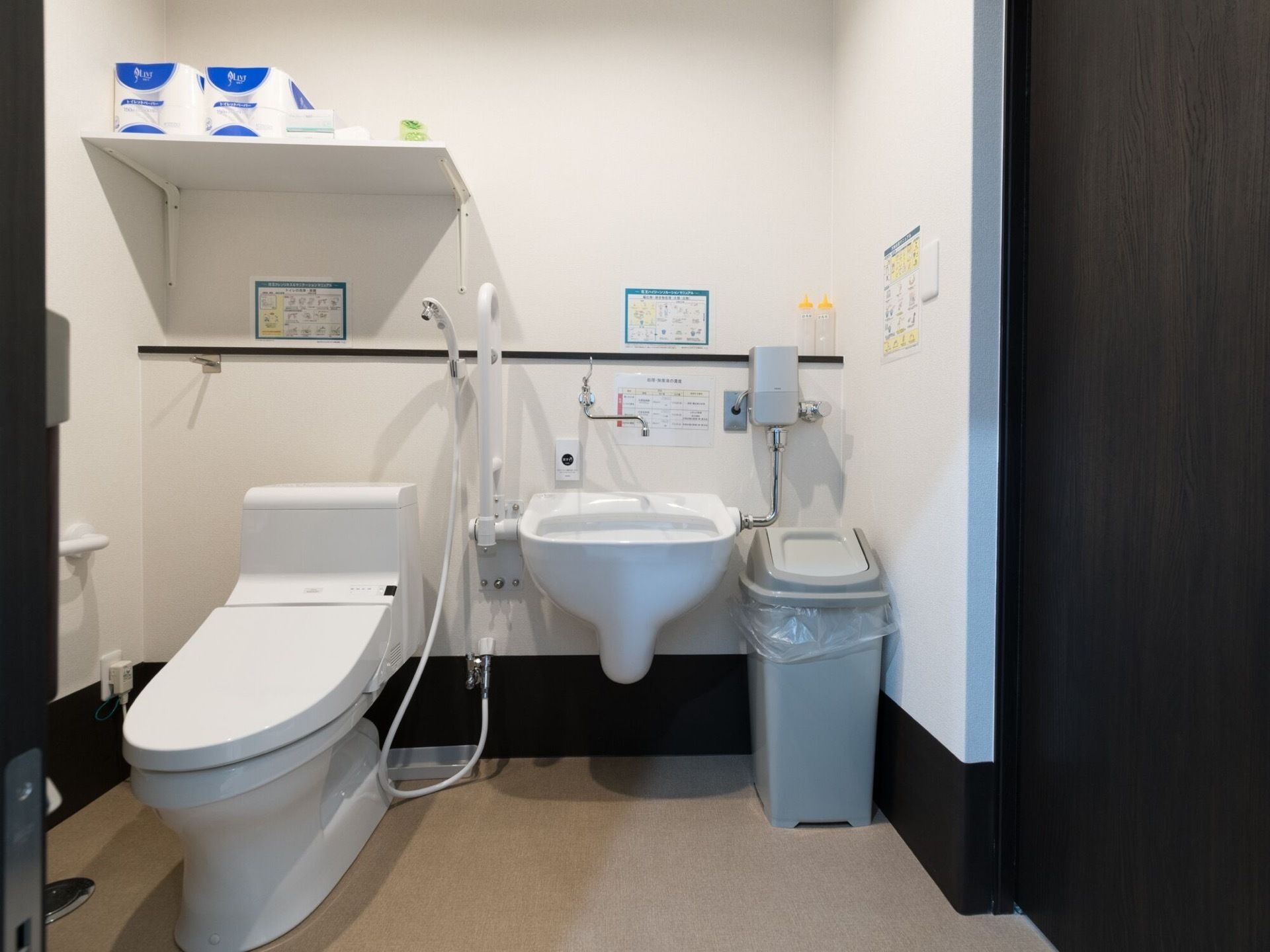 トイレには洋式便器が設置されている。便器の上部には棚があり、予備のトイレットペーパーが置かれている。