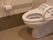 白で統一された清潔感のあるトイレである。温水洗浄便座や立ち上がりや座る際のサポートになるレバー、非常呼び出しブザーが完備されている。