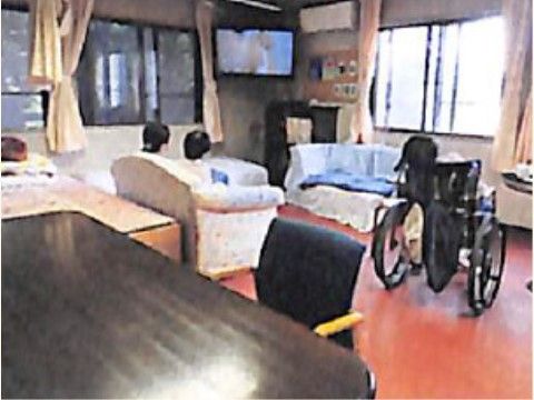 開放的なリビングの一角に、向かい合わせで白いソファーが２脚置かれている。壁にテレビが設置されている。