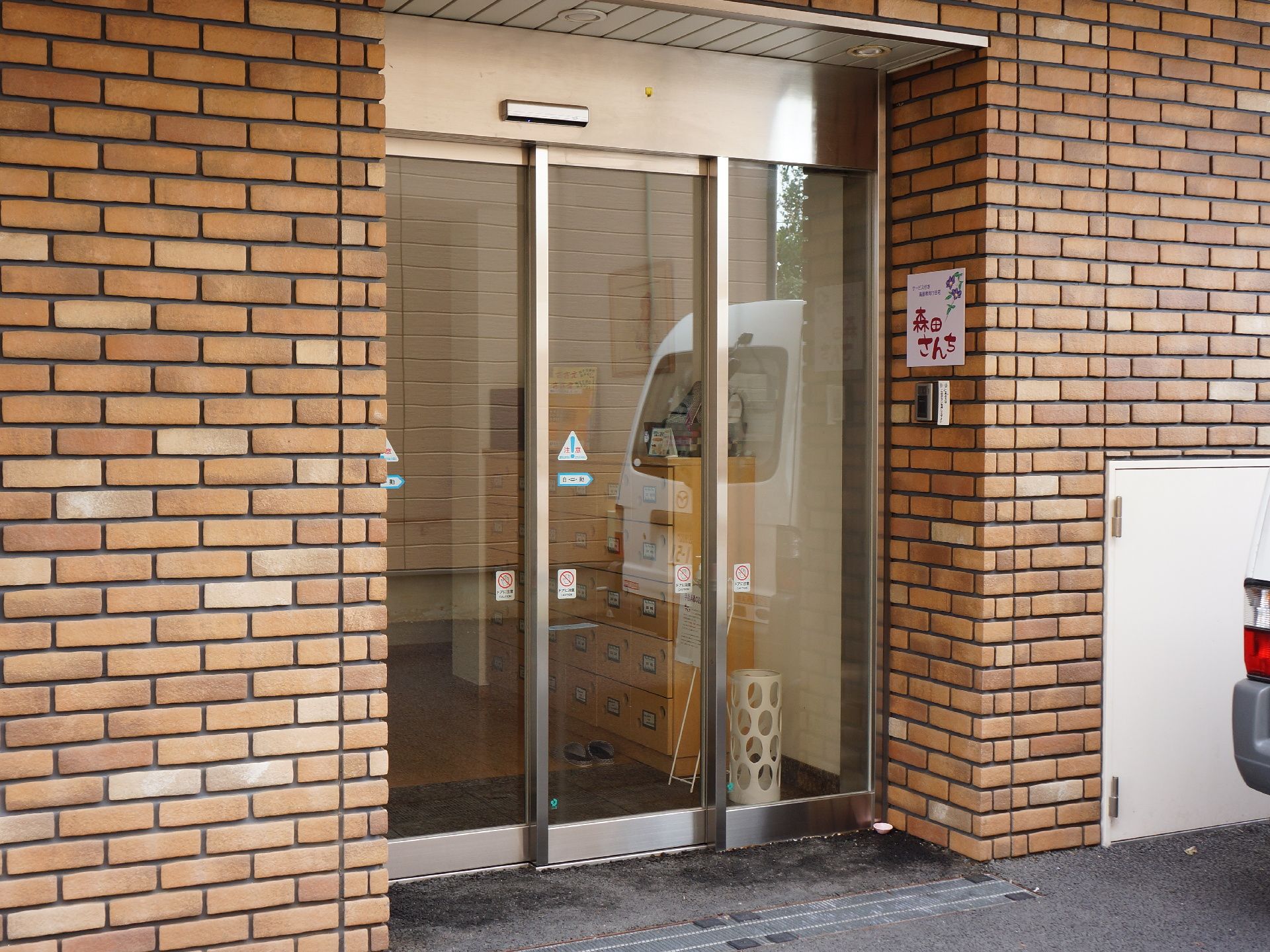 住宅の入口は、銀色の縁を持つガラス張りの自動扉だ。中には、下駄箱、傘立てなどがあり、段差はなくしてある。