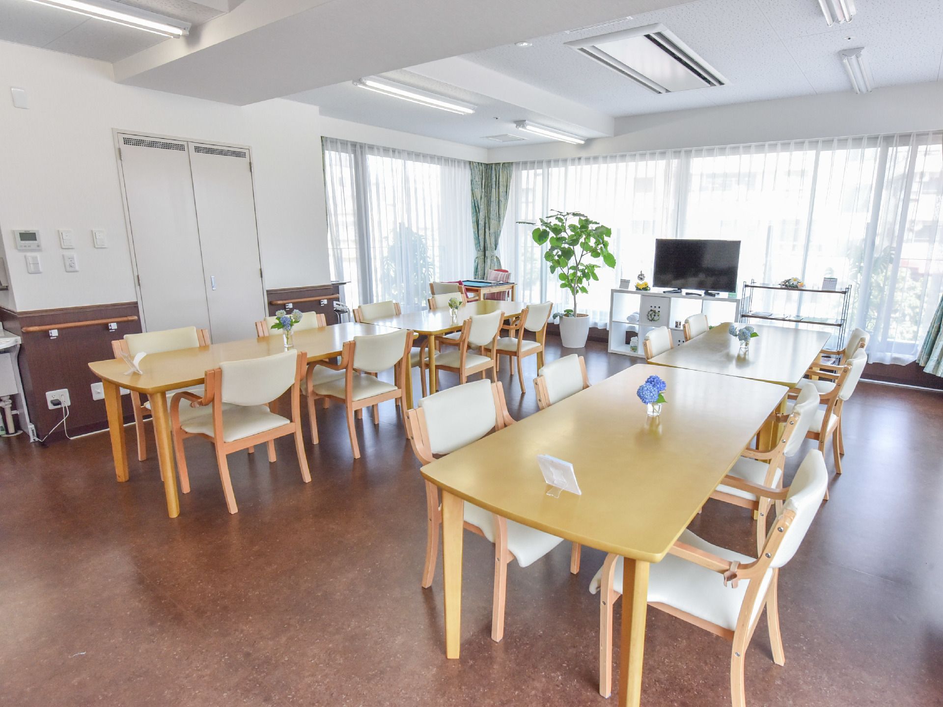 天井にはエアコンが付いていて、蛍光灯が一定間隔で取り付けられている。正面奥には窓があり、レースのカーテンが付いている。