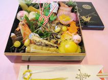 焼き魚と栗きんとん、野菜の煮物や黒豆などのおせち料理
