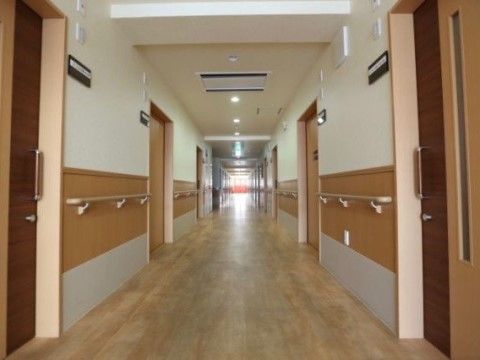 両側に手すりを備え、車椅子同士でもすれ違いができる広さを備えた廊下である。部屋のドアも、段差もなく出入りの楽なスライドドア。