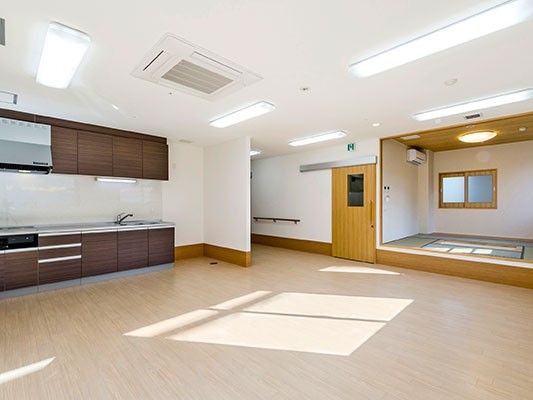 ブラウン系のキッチンは本格的で収納もたっぷり。畳敷きの小上がりも設置され明るい雰囲気。