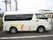 施設の駐車場にワンボックスカーが１台停められている。車の車体には、施設名と車椅子マークなどが書かれているのが見える。
