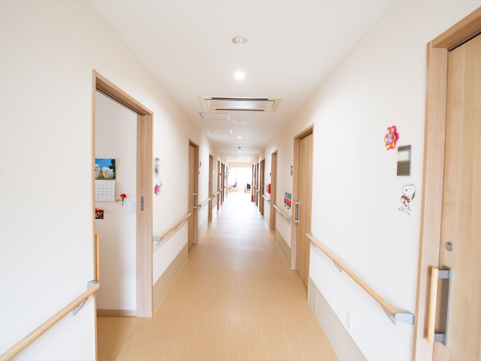 通路はまっすぐである。通路の両側には部屋の扉が並んでおり、手すりが取り付けられている。部屋の扉横には表札と犬のステッカーが貼られている。