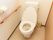 引き戸で仕切られた洋式トイレがある。床や壁は白基調で清潔感があり、木目調の手すりがある。