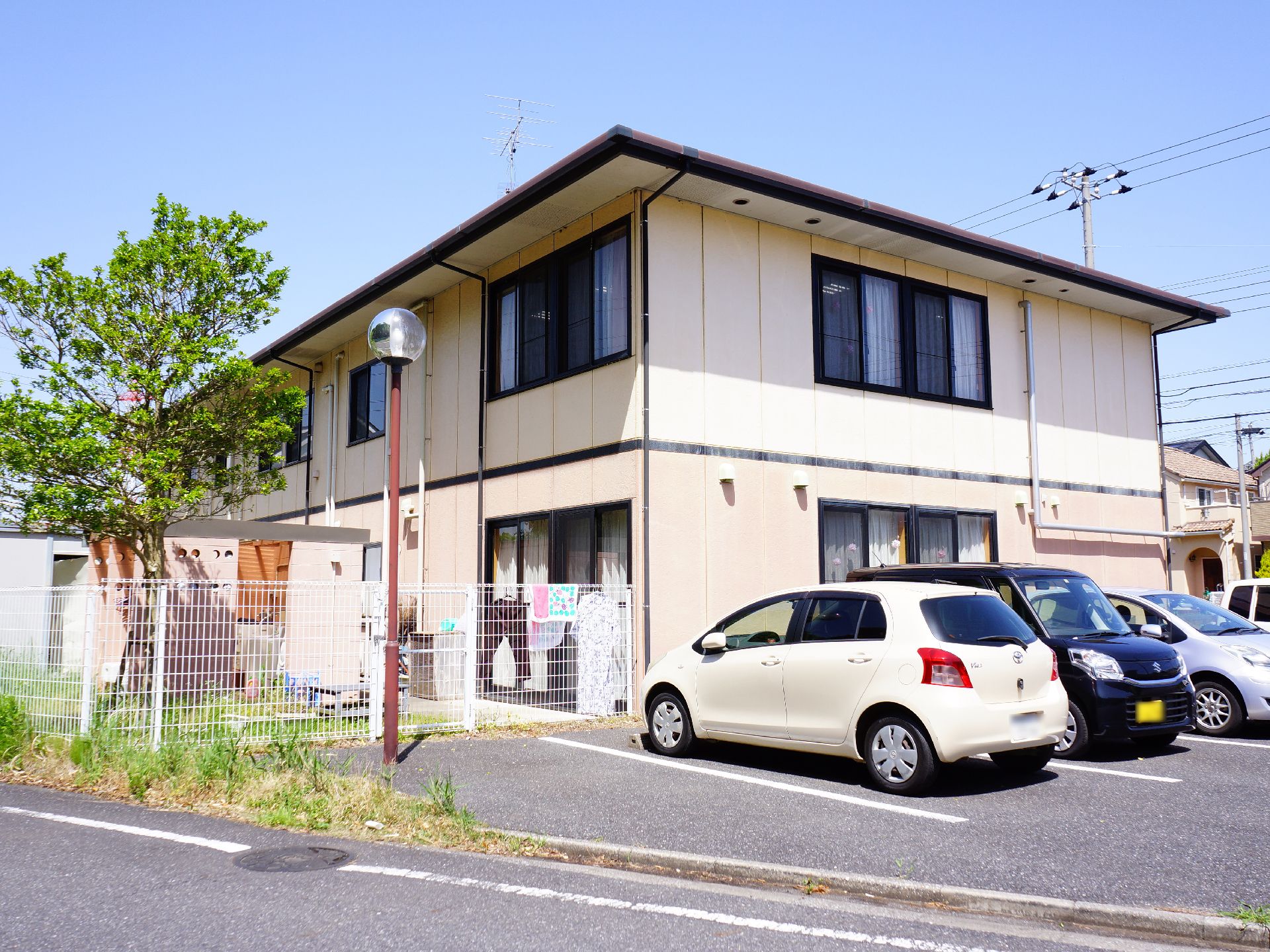 駐車場を完備した当施設。洗濯物や送り迎えも安心の施設となっている。道路に面しており、建物は二階建て。