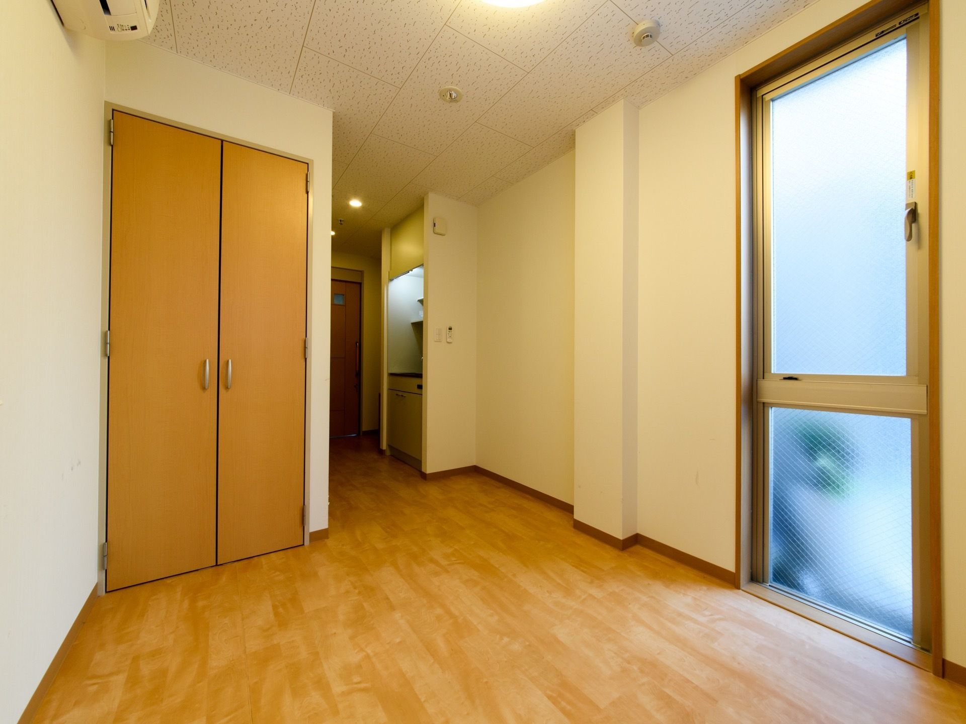 白い壁に囲まれた居室は広々として清潔感が保たれている。大き目の窓からは日光が差し込み、部屋中が明るい雰囲気である。