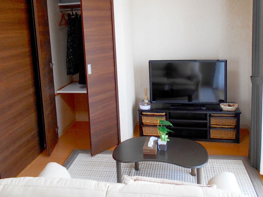 クローゼットやソファ、テレビなどが置かれている落ち着いた雰囲気の居住スペース