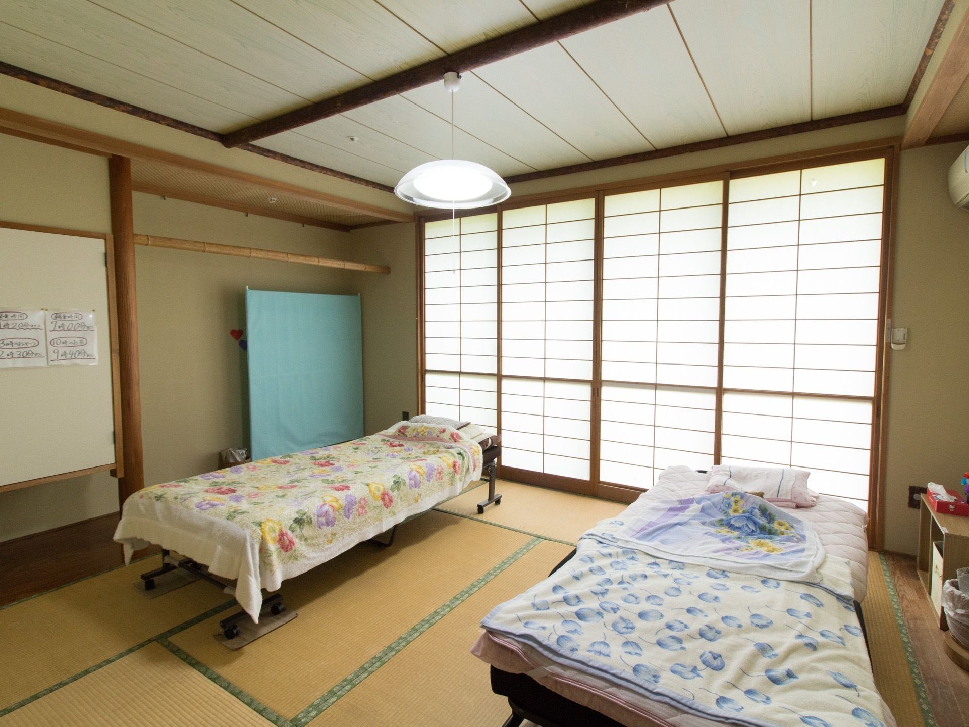 居室は畳敷きの８畳間となっている。床の間があり、窓には障子がはめられている。折り畳み式ベッドが２台置かれている。