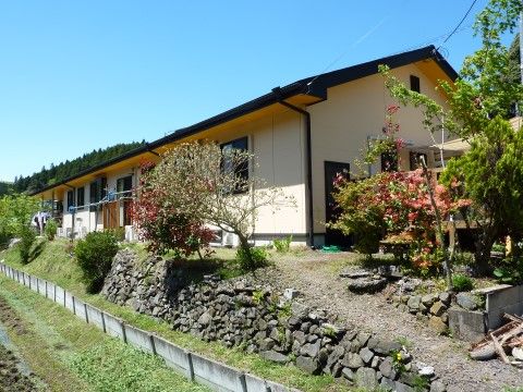 季節の移ろいが感じられる植栽のある、平屋造りの建物