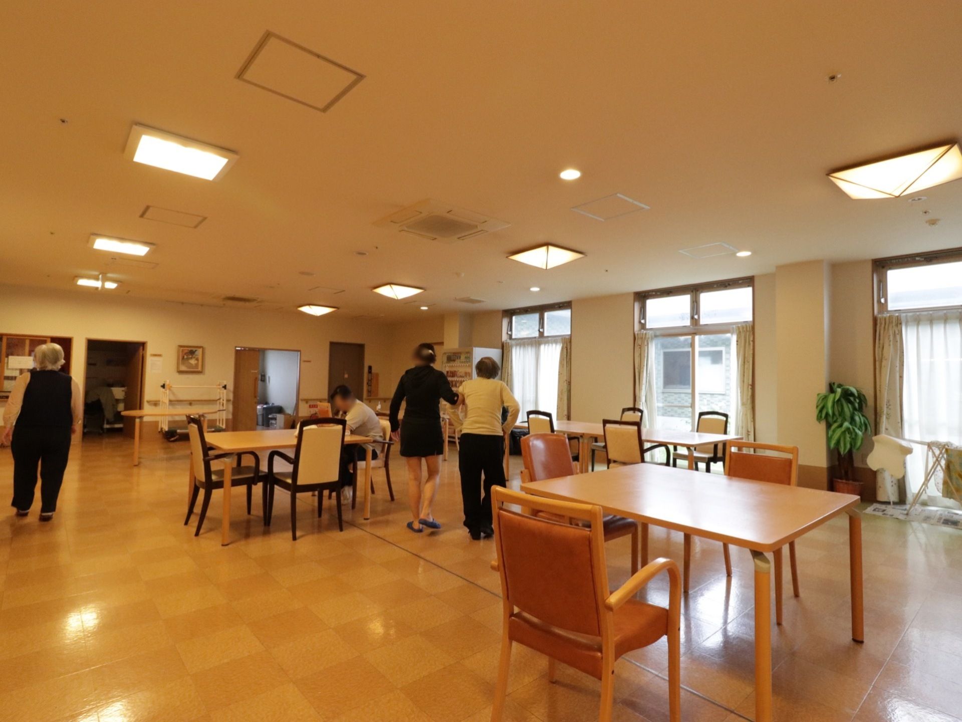 食堂は広く、ゆったりとしたスペースを確保している。通行の際にも、安全に移動できる。明るく開放的な空間で食事や団らんの時間を過ごせる。