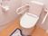 床はフローリングで、洋式のトイレが設置してある。ウォシュレットの操作パネルが座部横についている。左右に手すりがついている。