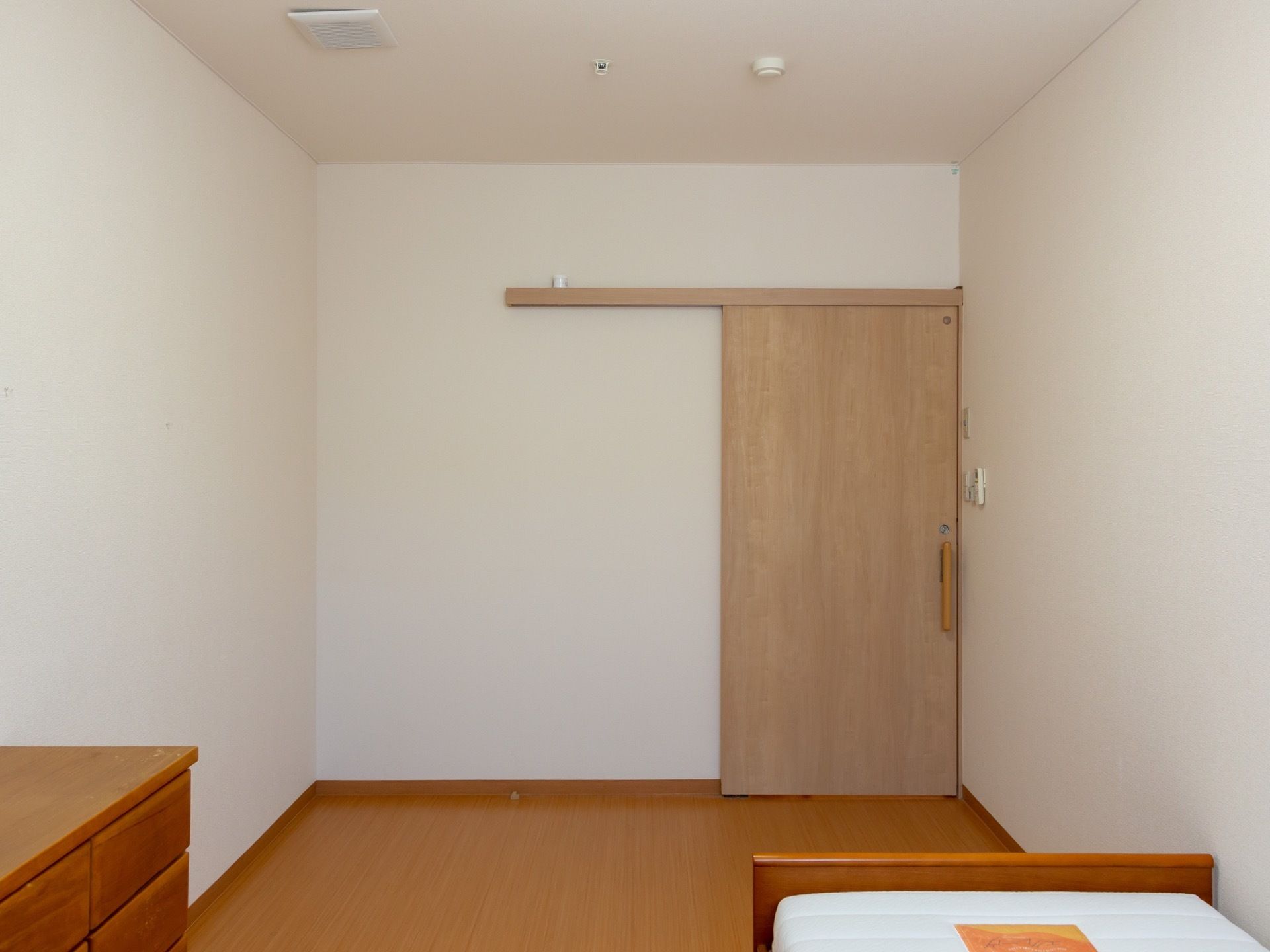 居室の出入口付近にはエアコンのリモコンが設置されている。入居者様は自由に好みの室温に調整することが可能である。
