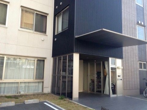 駐車場が完備されたシックでモダンな外観の施設入り口