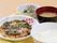 お好み焼き、白米、お味噌汁、おかずがトレーにのっている。柔らかいおかずなので、入居者様が食べやすい内容である。