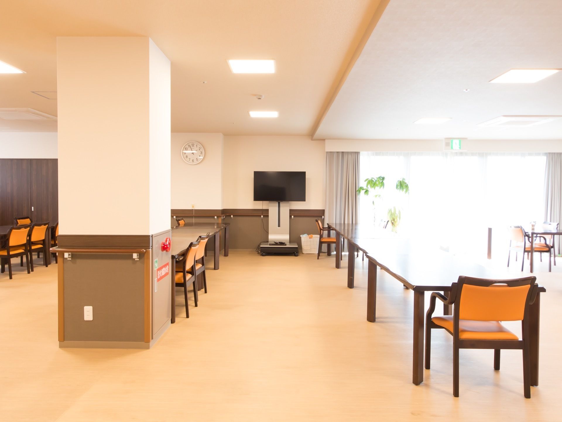 大勢の入居者様がご利用いただける、広々とした共有スペースである。テーブルに向かい合わせで座り、食事やレクリエーションが行われる。
