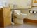 洋式トイレは、ウオッシュレットがついている。手すりが両サイドについている。収納ボックスが2つ設置。洗面所がある。