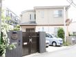 施設の入口は、黒を基調としたシックな印象である。横長で楕円形の形をした表札がある。インターホンが比較的低い位置に設置されている。