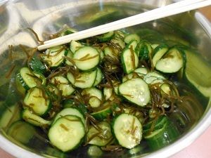 ボウルで輪切りのきゅうりと昆布を和える様子