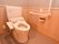 トイレにはお尻洗浄がついた洋式便器を設置している。また壁には手すりがあり、緊急時の呼び出しボタンを備え付けている。
