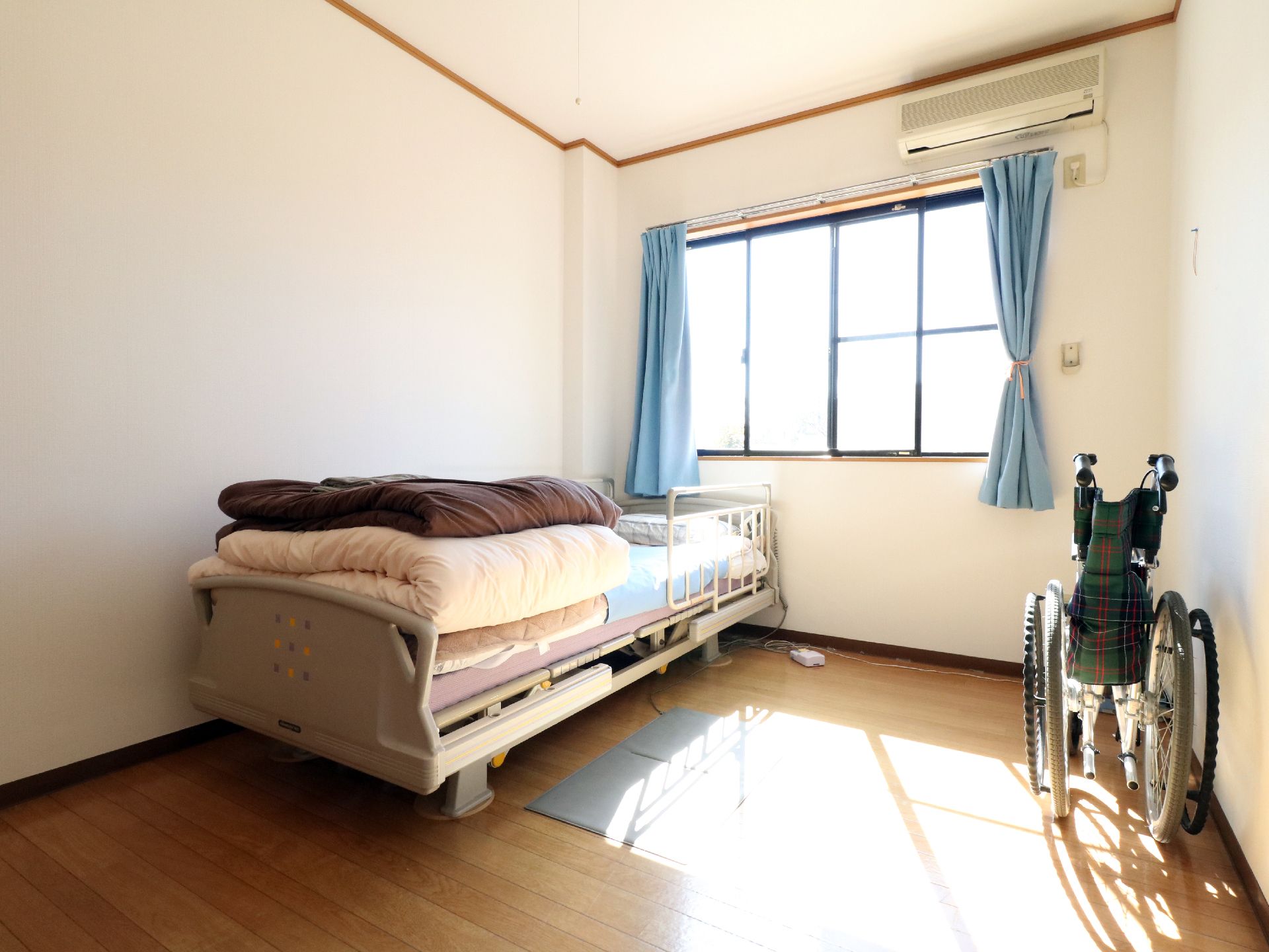 起き上がり補助の為の電動ベッドと車椅子を兼ね備えた居住スペース