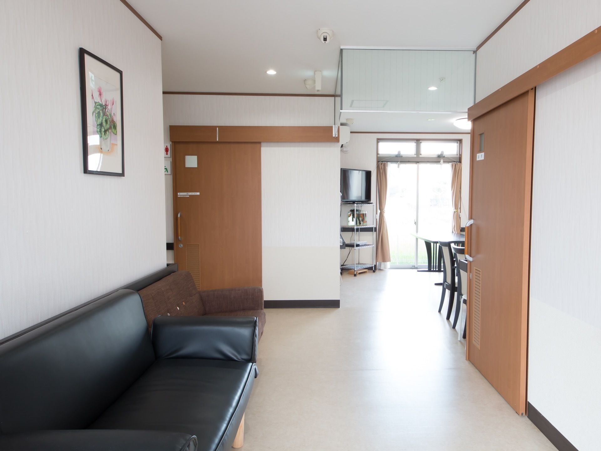 広めの通路の角部である。２方向それぞれの部屋に大きめの引き戸がある。通路の角奥に別スペースが続いている。