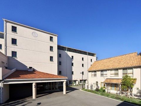 ルーフ付きエントランスのある旅館のような5階建て施設外観