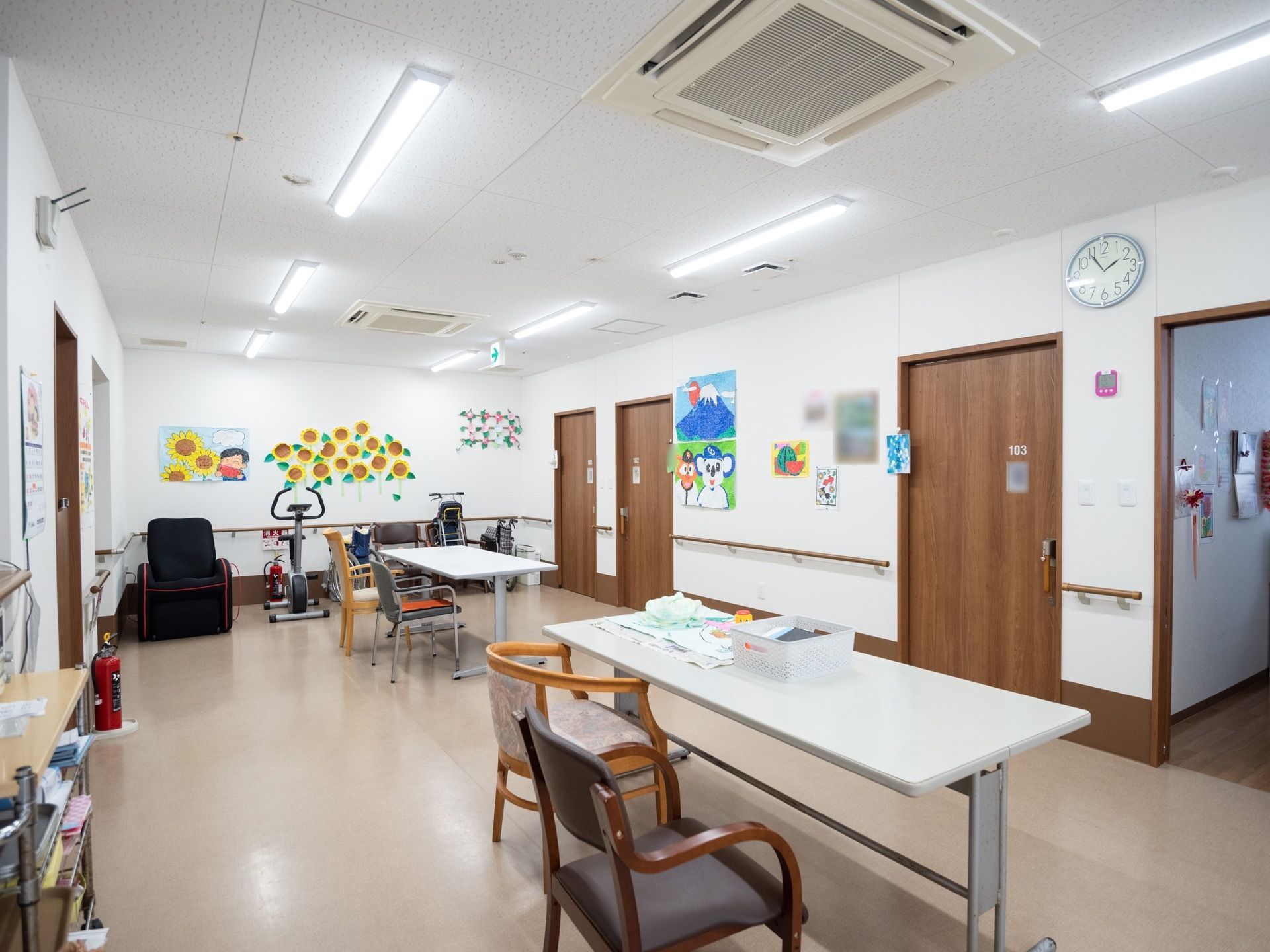 壁に手作りの装飾が施されているリビングスペースで、通路と居室の間は段差のない床となっている。