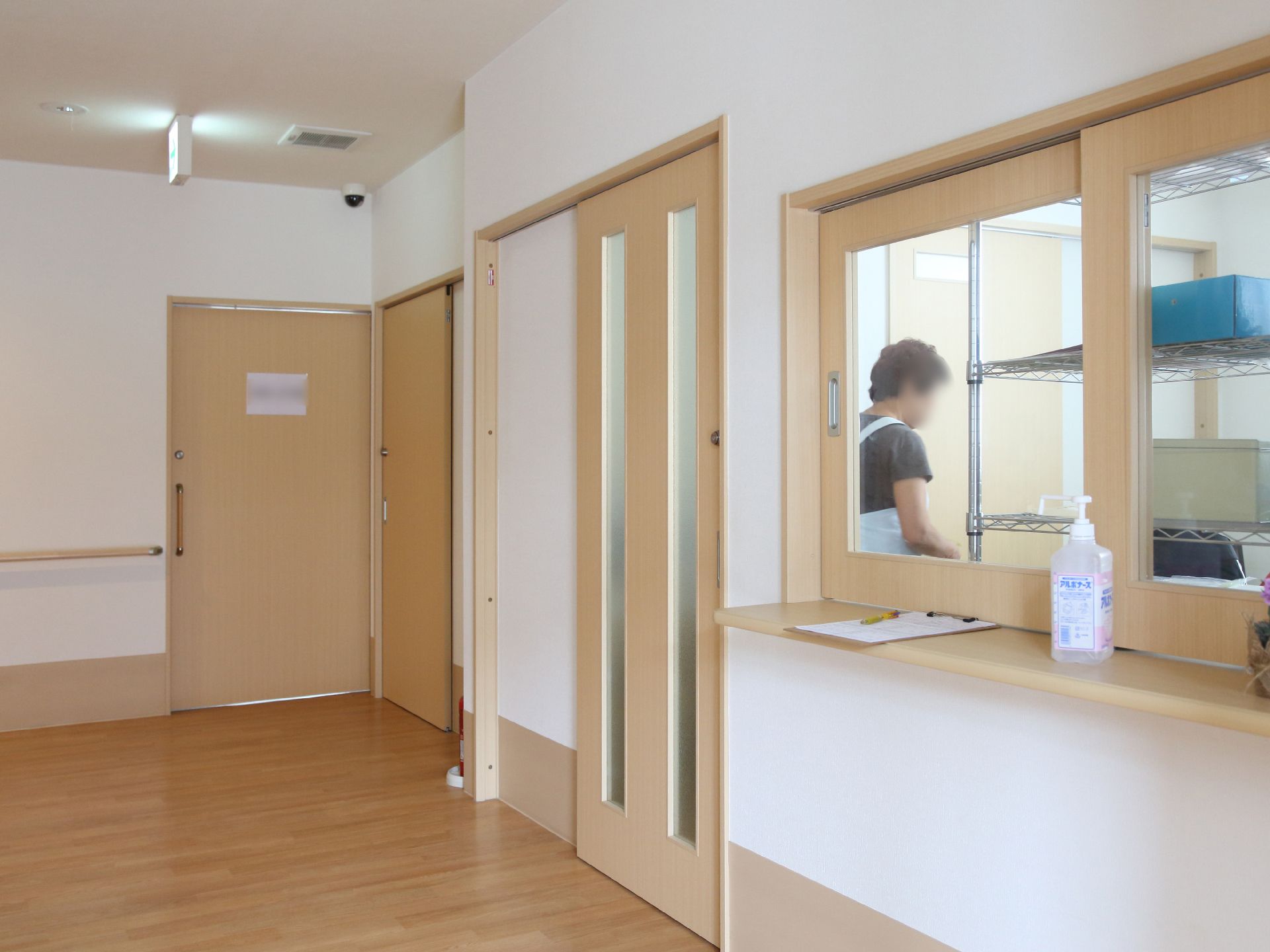 白と茶を基調としていて、明るく、窓口が取り付けられているスタッフルーム