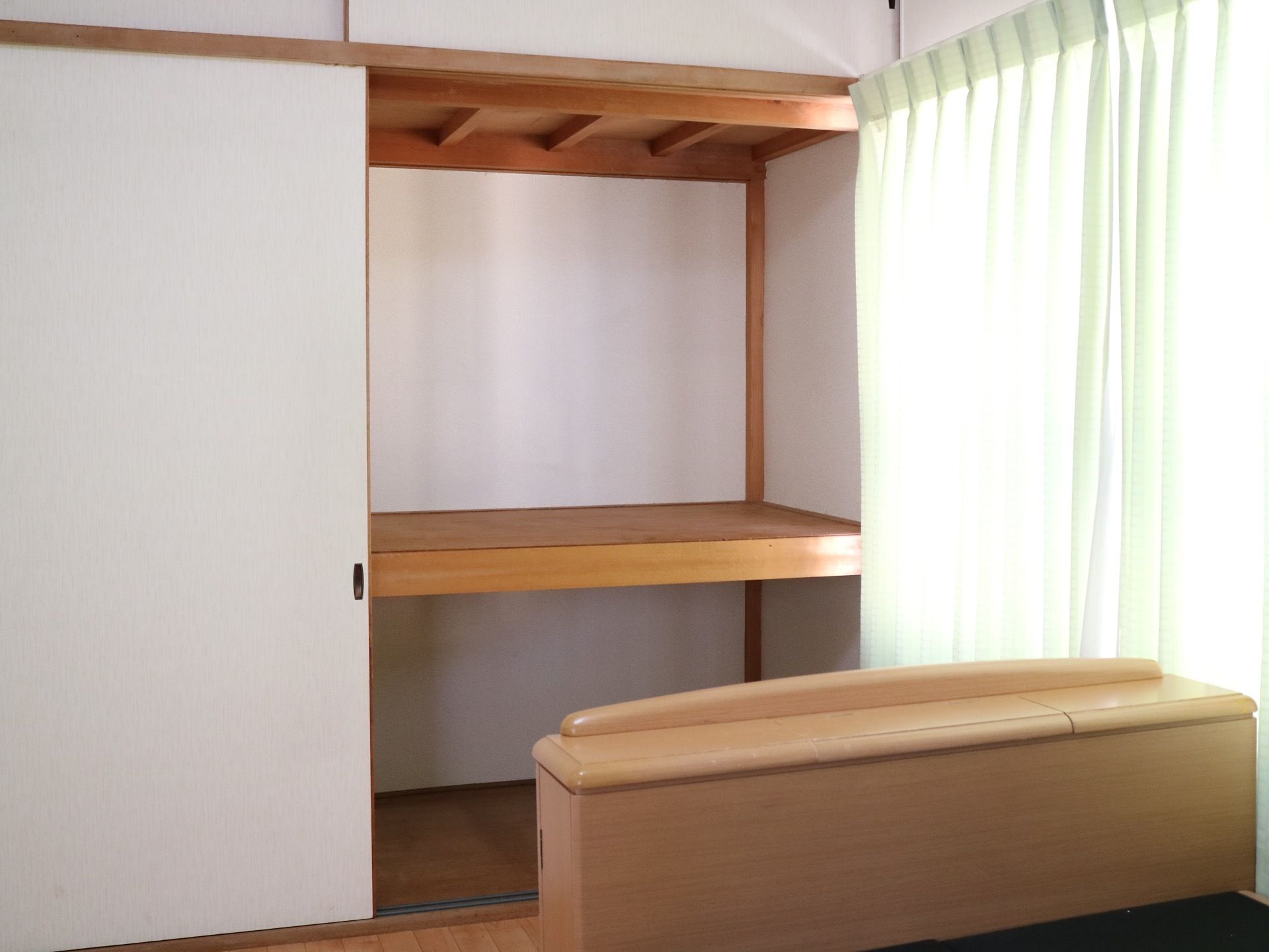 居室の収納スペースは２段となっており、広い。天井は細い横梁が入っていて、はしごのようなデザインである。