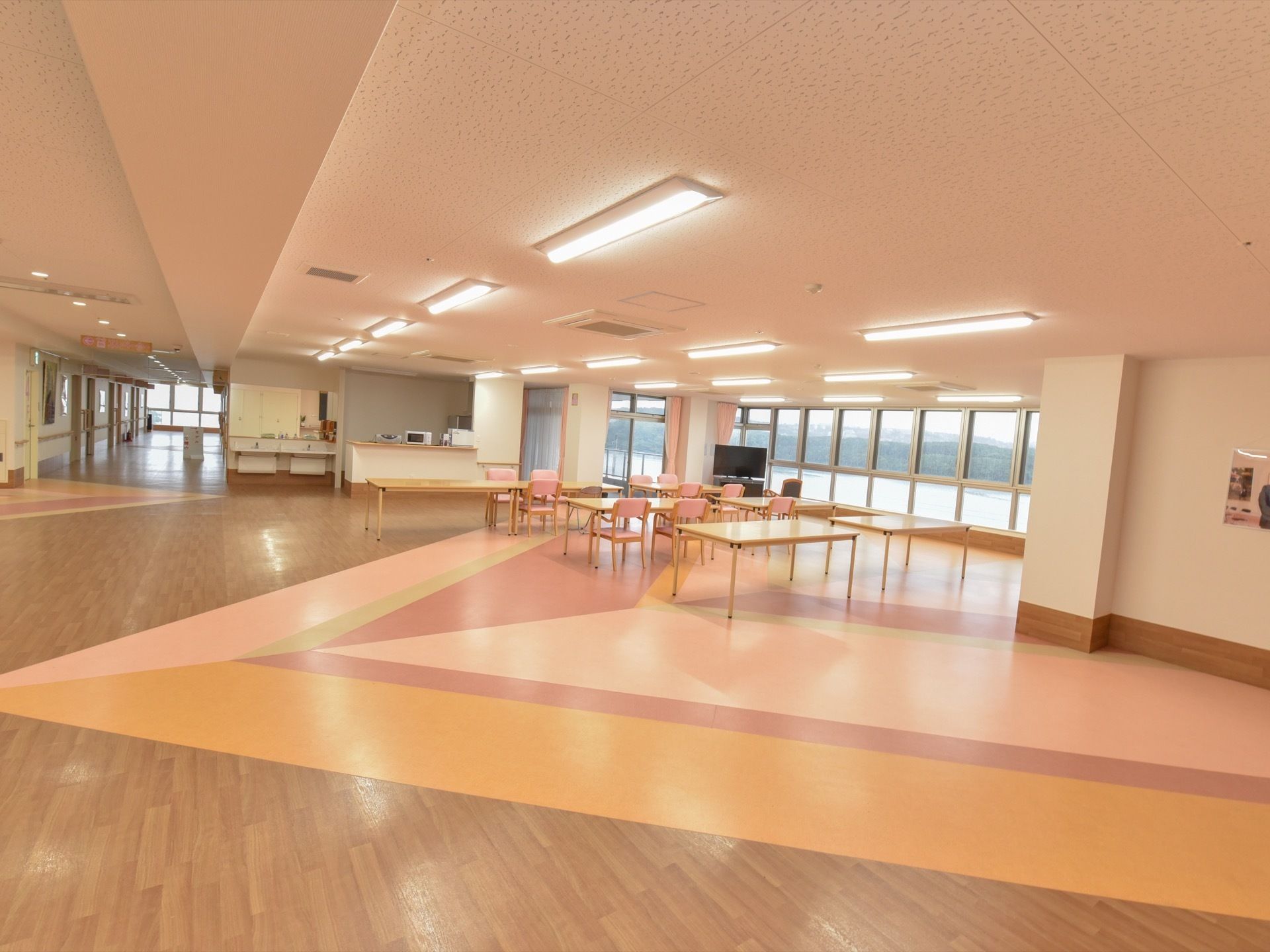 各居室に繋がる通路と食堂の間には仕切りがない。足元に障害物がなく、歩行の際も安心である。窓が多く自然光が入ってくる。