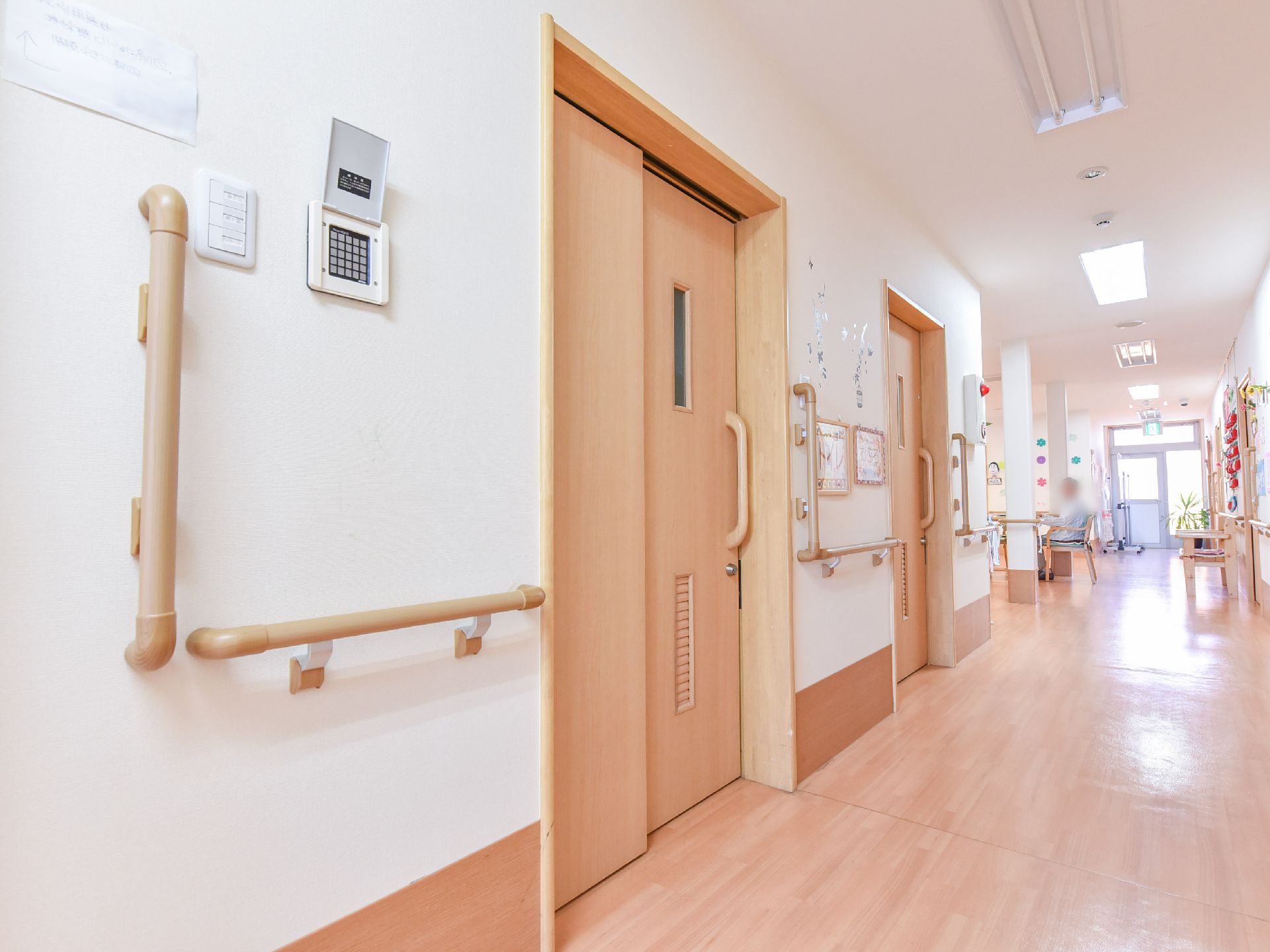 左側の壁には縦横に手すりが取り付けられている。各部屋への扉はスライド式になっており廊下は長く伸びている。