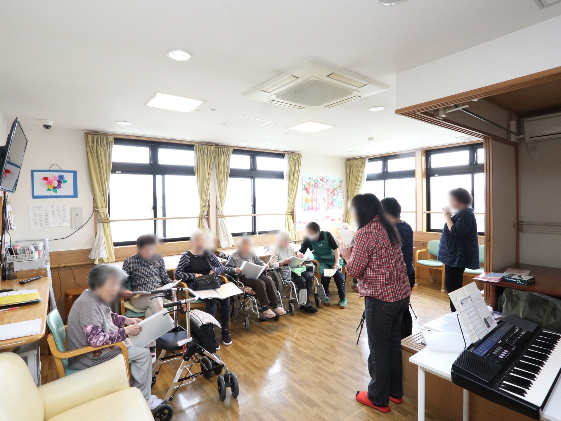 共有スペースでは、たくさんの入居者様たちが集まり、電子ピアノなどを利用して歌を歌ったりして楽しんでいる。
