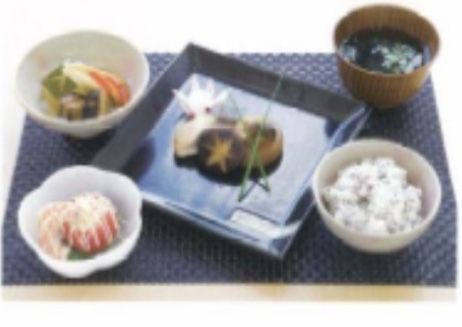 四角い網状のランチョンマットに配膳されている食事の一例