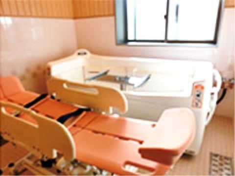 介護浴槽の側にストレッチャーが用意されている。ストレッチャーには身体を固定するためのベルトや、落下防止用のフェンスが付いている。