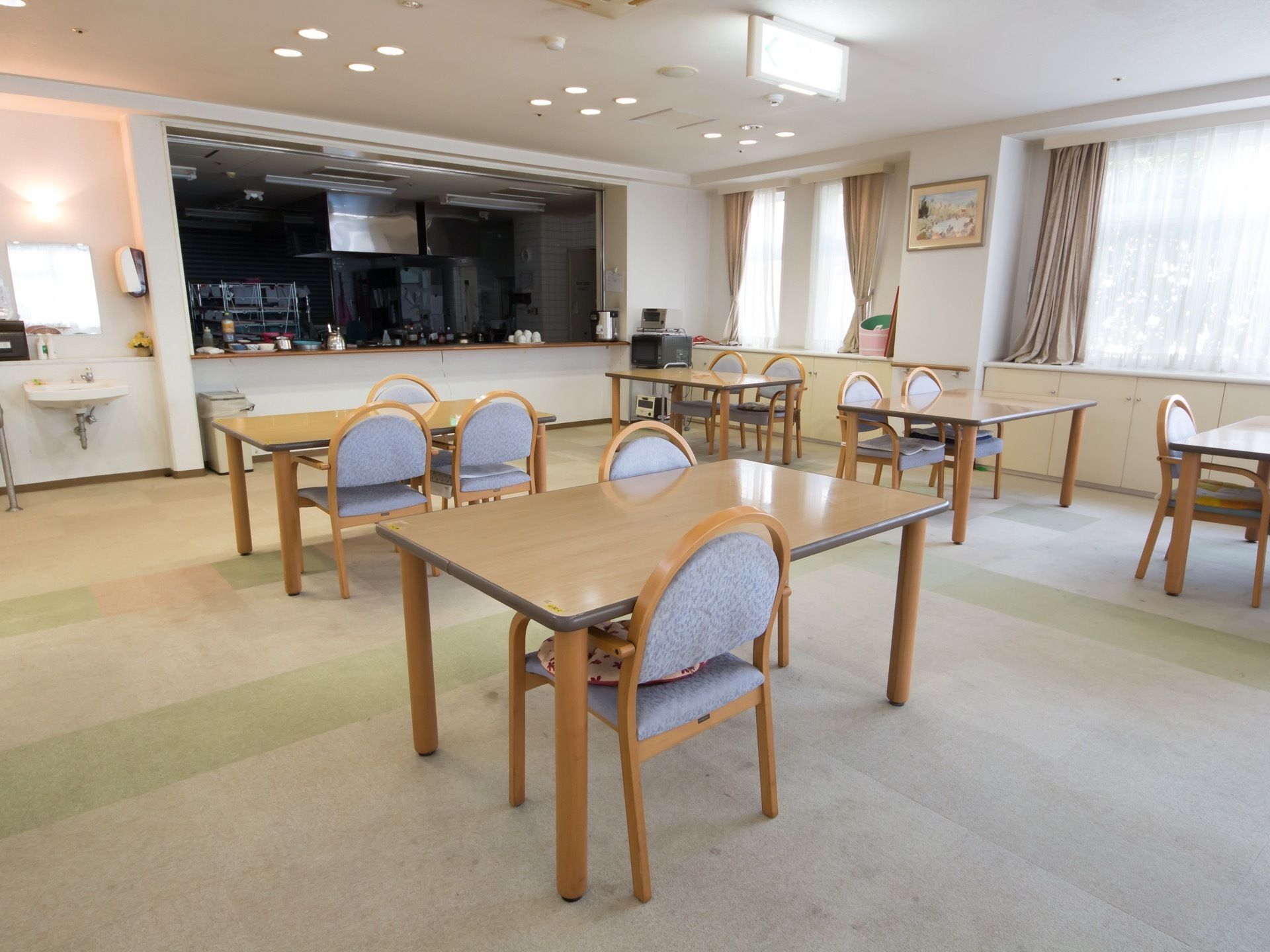 共有のリビングを兼ねた食堂に隣接して、カウンターの奥に規模の大きいキッチンが設けられているのが見える。