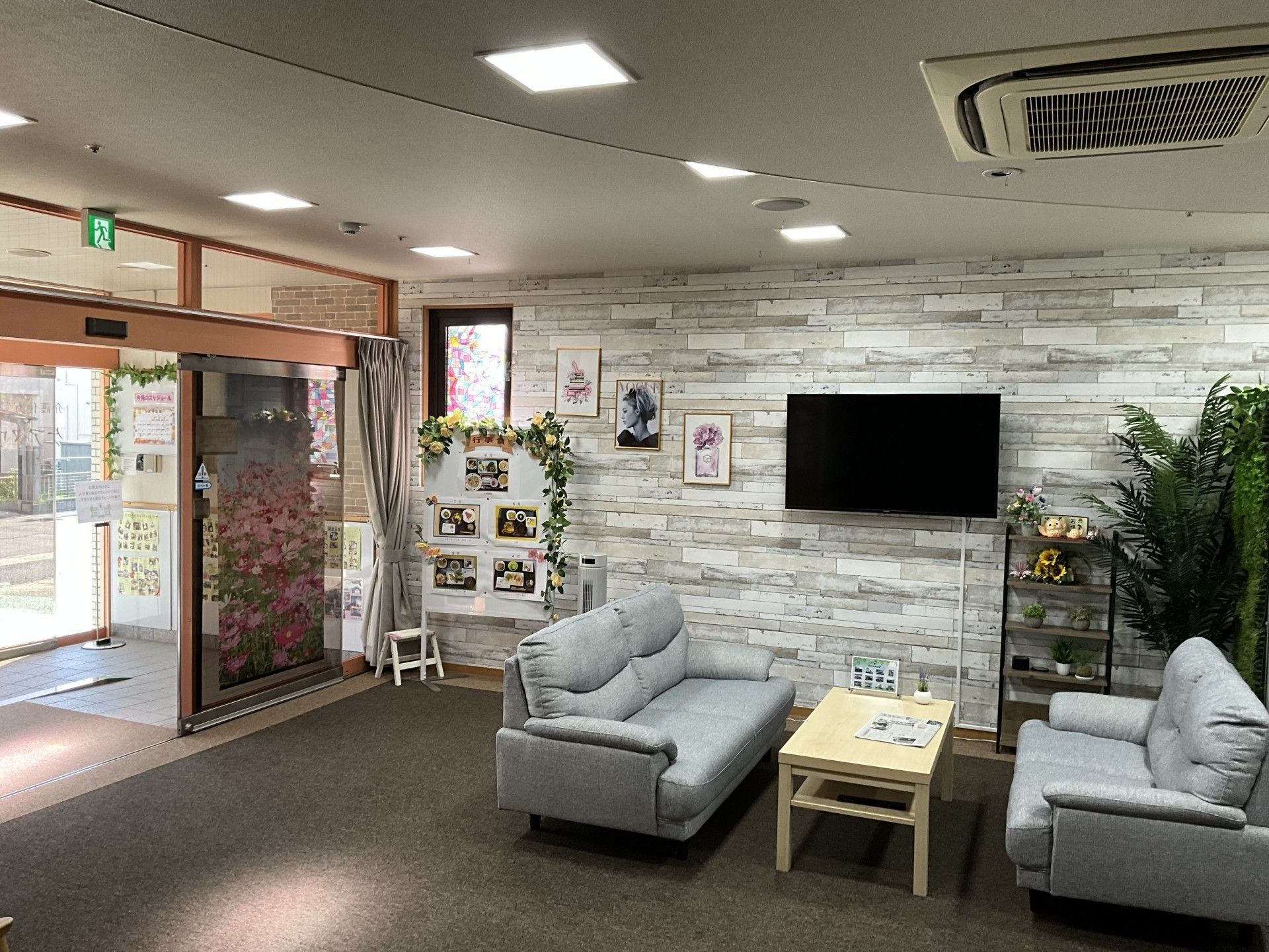 スタッフの事務所のカウンターの前にあるベージュのソファセット