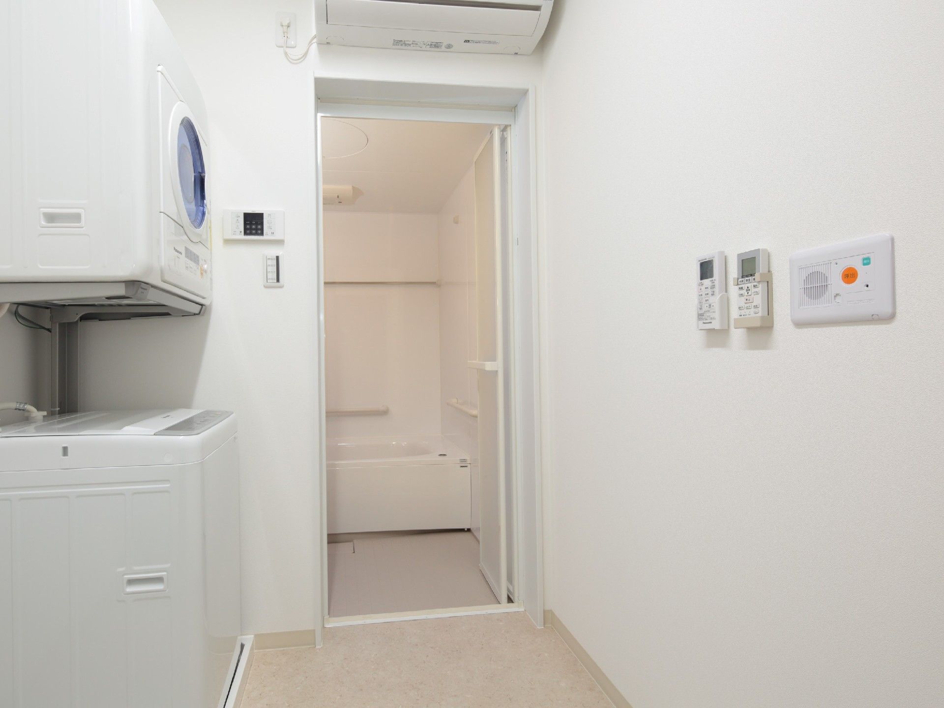洗濯機と乾燥機が置かれた脱衣所と一人用の浴槽が設置された浴室の間に段差はない。