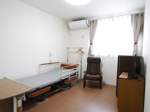 居室には生活に必要なエアコンや照明器具が設置されている。またリクライニング機能がついた、介護用ベッドも用意されている。