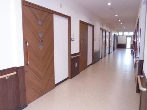 手すりが備え付けらえた廊下は、車椅子での移動が楽にできる広さがある。扉が引き戸になっているため、少ない力でも開け閉めすることができる。