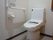 真っ白なトイレにはL字型の手すりが設置されている。手すりに掴まることで安全に立ち座りができ、身体への負担を軽くすることができる。