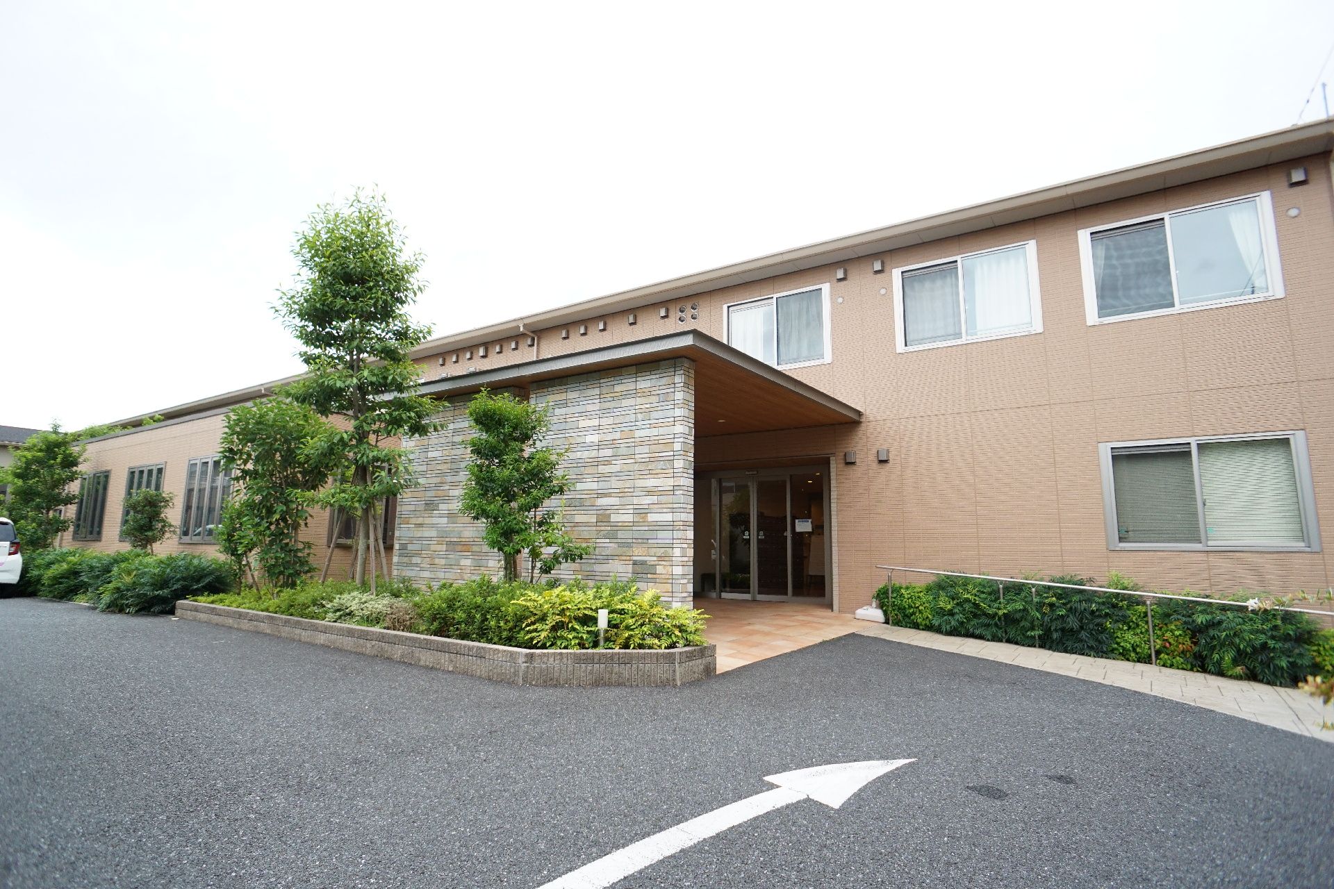 ２階建てであり、駐車場が近隣にある介護施設の外観