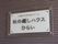 ダークブラウンの外壁に掲げられた表札である。上部には、小さい文字の大きさで施設の種類があり、その下に大きな文字で施設名がある。